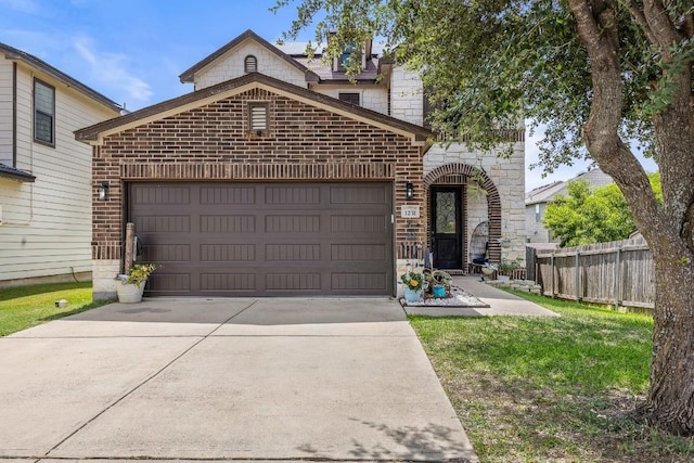 1231 Tumbleweed Trl, Temple, TX 76502 - view of front of house with brick siding, a garage, concrete driveway, and stone siding