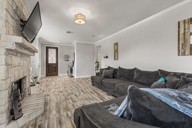 1231 Tumbleweed Trl, Temple, TX 76502 - living area featuring ornamental molding, arched walkways, wood finished floors, and a stone fireplace