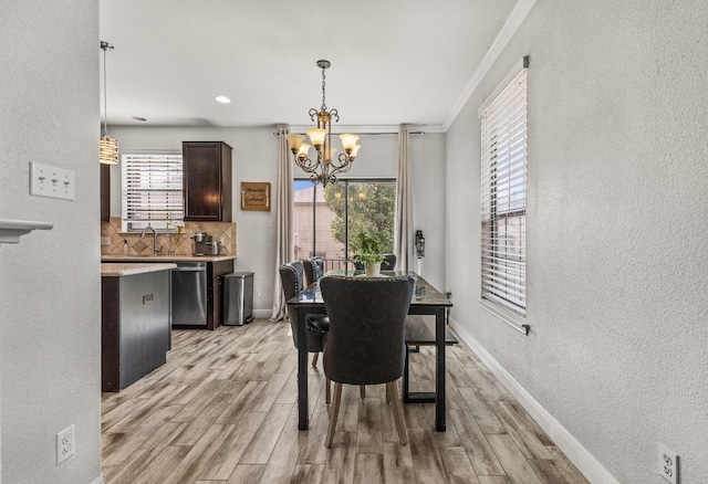 1231 Tumbleweed Trl, Temple, TX 76502 - dining space with a chandelier, light wood-style flooring, a textured wall, crown molding, and recessed lighting