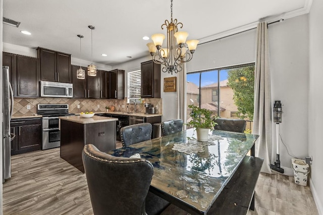 1231 Tumbleweed Trl, Temple, TX 76502 - dining area featuring light wood-style flooring, a chandelier, and recessed lighting