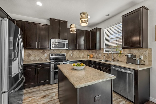 1231 Tumbleweed Trl, Temple, TX 76502 - kitchen featuring stainless steel appliances, light wood finished floors, dark brown cabinets, decorative light fixtures, and recessed lighting