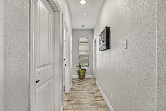 1231 Tumbleweed Trl, Temple, TX 76502 - hallway featuring light wood-style flooring, a textured wall, and recessed lighting