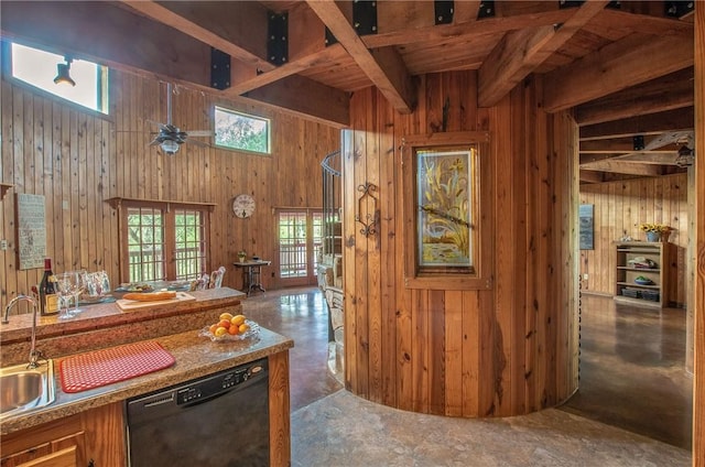 450 Oakwood Loop, San Marcos, TX 78666 - kitchen with black dishwasher, wooden walls, open floor plan, and concrete floors