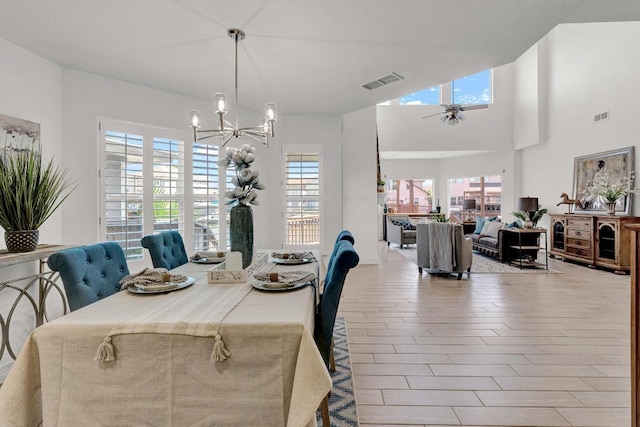 13517 Carlos Fifth Ct, Corpus Christi, TX 78418 - dining area with plenty of natural light, a chandelier, a ceiling fan, wine cooler, and a high ceiling