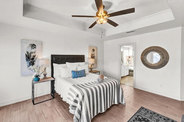 13517 Carlos Fifth Ct, Corpus Christi, TX 78418 - bedroom featuring a raised ceiling, wood finished floors, crown molding, ceiling fan, and ensuite bath