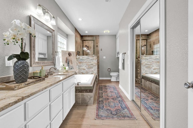 13517 Carlos Fifth Ct, Corpus Christi, TX 78418 - bathroom with vanity, a bath, a shower stall, recessed lighting, and wood finished floors