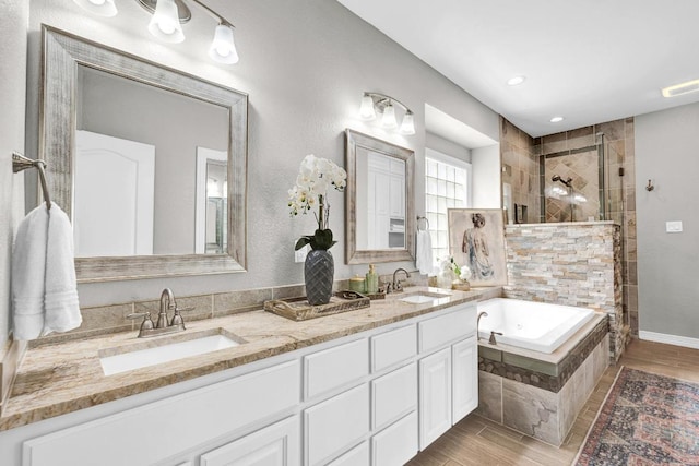 13517 Carlos Fifth Ct, Corpus Christi, TX 78418 - full bath featuring tiled shower, a bath, double vanity, and wood finished floors