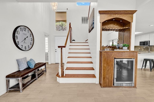 13517 Carlos Fifth Ct, Corpus Christi, TX 78418 - foyer entrance with beverage cooler, stairs, and recessed lighting