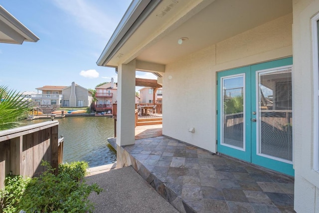 13517 Carlos Fifth Ct, Corpus Christi, TX 78418 - view of patio featuring french doors and a water view