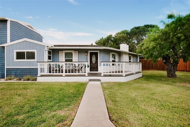134 Sinclair St, Corpus Christi, TX 78411 - view of front of home with a chimney, covered porch, and board and batten siding