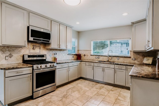 134 Sinclair St, Corpus Christi, TX 78411 - kitchen featuring stainless steel appliances, backsplash, gray cabinets, dark stone countertops, and recessed lighting