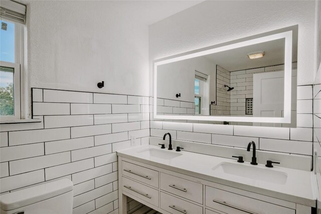 134 Sinclair St, Corpus Christi, TX 78411 - bathroom with tile walls, double vanity, backsplash, and a tile shower