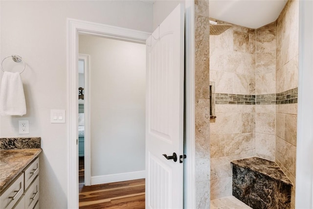 134 Sinclair St, Corpus Christi, TX 78411 - bathroom with a tile shower, vanity, and wood finished floors