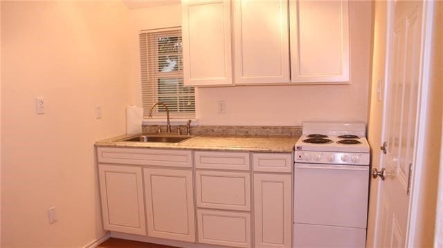 502 Toliver St, Bastrop, TX 78602 - kitchen featuring electric stove and light stone counters