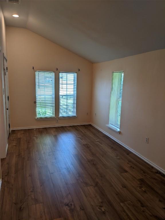 502 Toliver St, Bastrop, TX 78602 - empty room with dark wood finished floors and lofted ceiling
