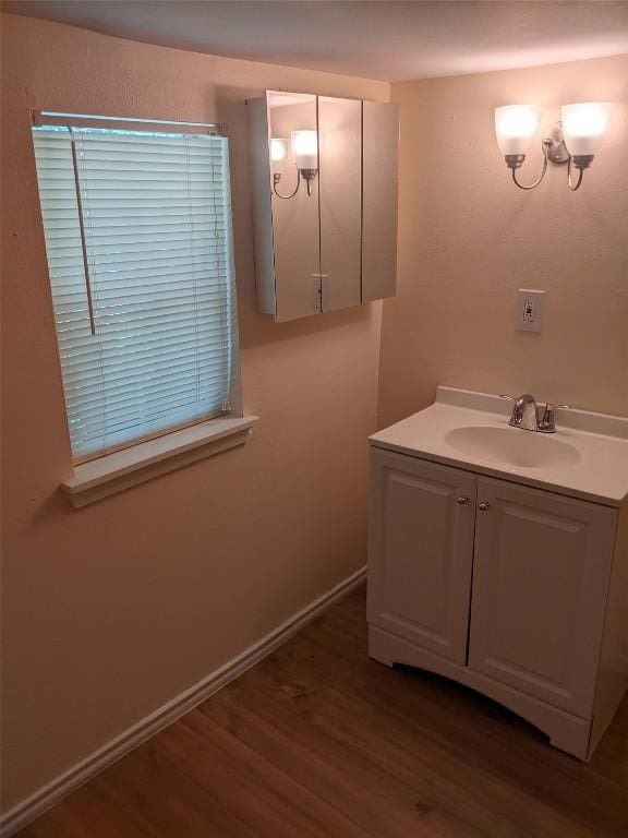 502 Toliver St, Bastrop, TX 78602 - bathroom featuring wood finished floors and vanity