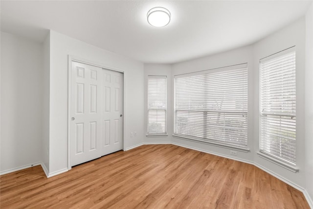 237 Baldwin St, Hutto, TX 78634 - unfurnished bedroom with light wood finished floors and a closet
