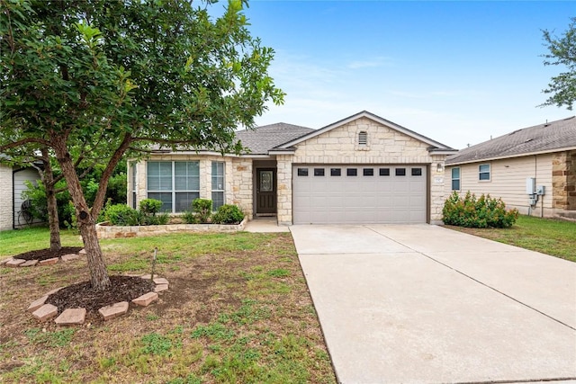 237 Baldwin St, Hutto, TX 78634 - single story home with a garage, stone siding, driveway, and a front yard