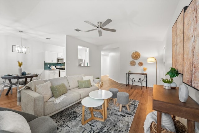 237 Baldwin St, Hutto, TX 78634 - living room with a ceiling fan, a chandelier, and light wood finished floors