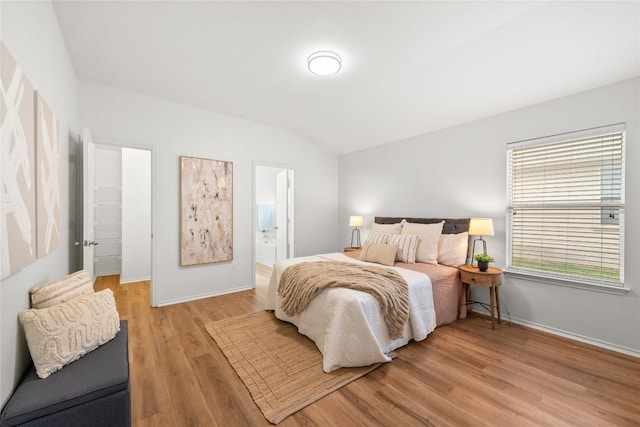 237 Baldwin St, Hutto, TX 78634 - bedroom featuring lofted ceiling, light wood-type flooring, and ensuite bath