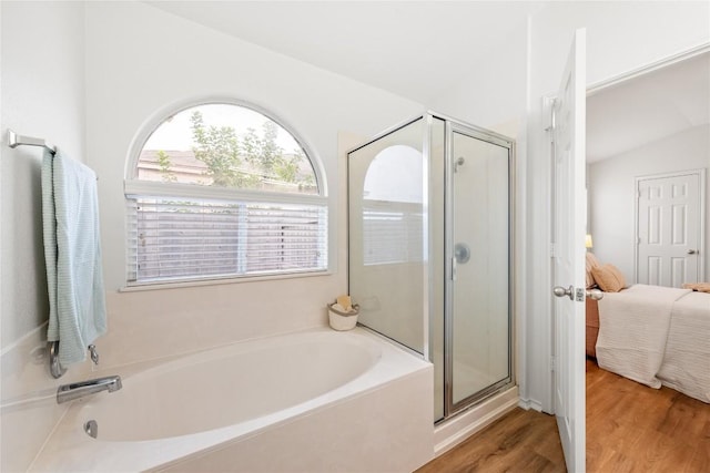 237 Baldwin St, Hutto, TX 78634 - full bathroom featuring ensuite bath, a garden tub, a shower stall, and wood finished floors