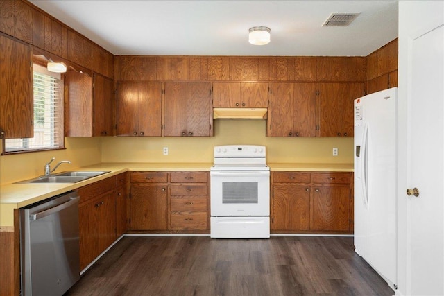 114 Pecan Dr, Elgin, TX 78621 - kitchen featuring white appliances, under cabinet range hood, brown cabinets, light countertops, and dark wood-type flooring