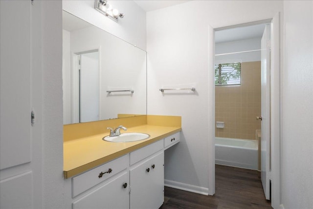 114 Pecan Dr, Elgin, TX 78621 - full bathroom featuring vanity, wood finished floors, and shower / washtub combination