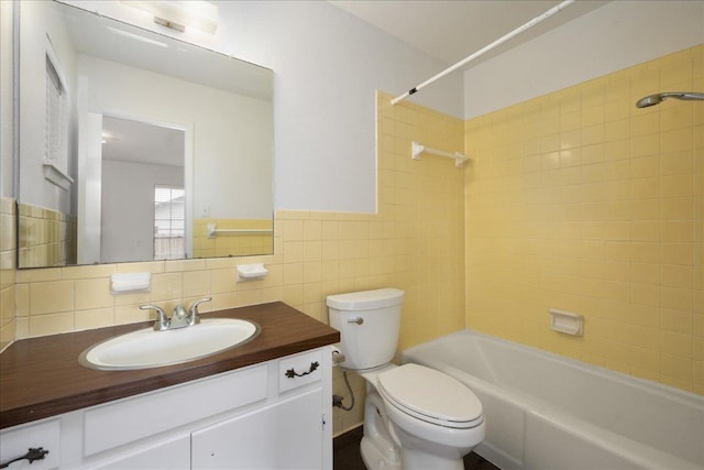 114 Pecan Dr, Elgin, TX 78621 - full bath featuring bathing tub / shower combination, vanity, and tile walls