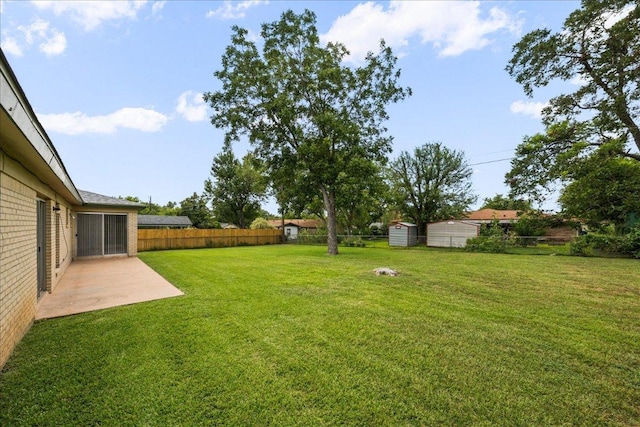 114 Pecan Dr, Elgin, TX 78621 - fenced backyard with a patio and a storage shed