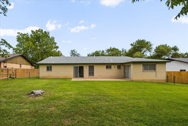 114 Pecan Dr, Elgin, TX 78621 - back of property featuring a patio area, a fenced backyard, and brick siding