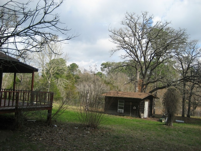 169 Pine Song, Bastrop, TX 78602 - view of grassy yard with a wooden deck and an outdoor structure