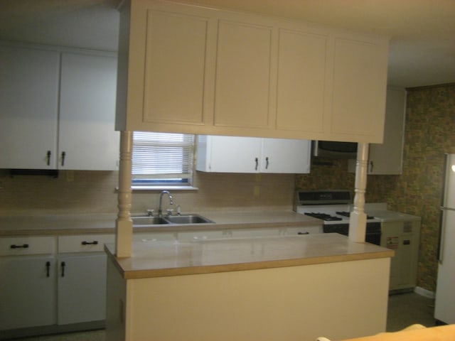 169 Pine Song, Bastrop, TX 78602 - kitchen featuring white cabinets, white appliances, light countertops, and wallpapered walls
