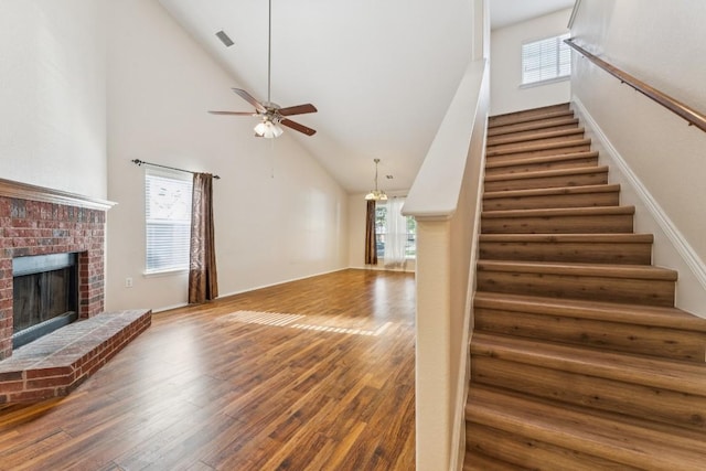 9004 Postvine Dr, Austin, TX 78724 - staircase featuring high vaulted ceiling, healthy amount of natural light, wood finished floors, and a fireplace