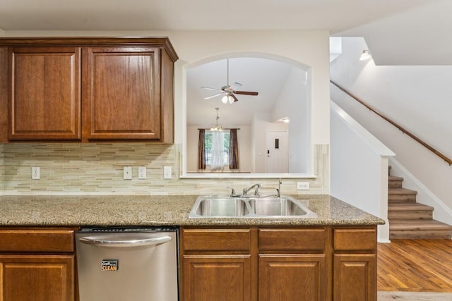 9004 Postvine Dr, Austin, TX 78724 - kitchen featuring stainless steel dishwasher, a ceiling fan, tasteful backsplash, vaulted ceiling, and brown cabinets