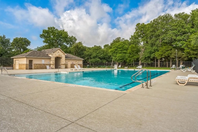 9004 Postvine Dr, Austin, TX 78724 - community pool featuring a patio area and view of wooded area