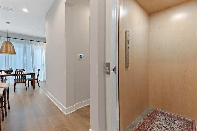 4510 Unity Cir Unit 258, Austin, TX 78731 - corridor featuring elevator, wood finished floors, and recessed lighting