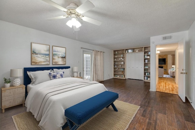 7400 Ophelia Dr, Austin, TX 78752 - bedroom featuring a textured ceiling, dark wood finished floors, and ceiling fan