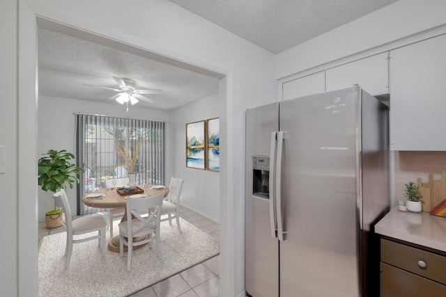 7400 Ophelia Dr, Austin, TX 78752 - dining room with a textured ceiling, light tile patterned floors, and a ceiling fan