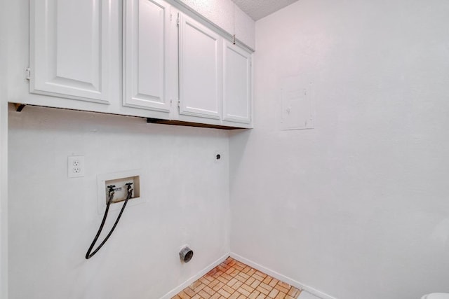 7400 Ophelia Dr, Austin, TX 78752 - washroom with cabinet space, electric dryer hookup, hookup for a washing machine, and brick patterned flooring