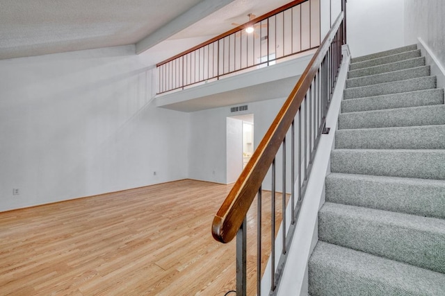 7400 Ophelia Dr, Austin, TX 78752 - stairs featuring wood finished floors and a high ceiling