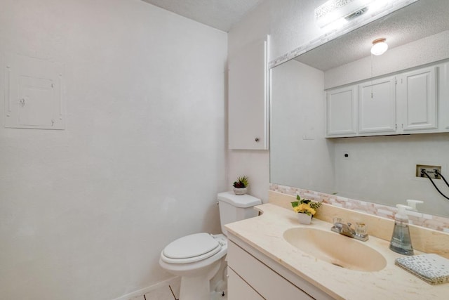 7400 Ophelia Dr, Austin, TX 78752 - half bath featuring vanity, electric panel, tile patterned flooring, and a textured ceiling