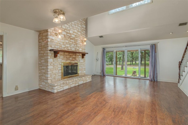 2981 Vivroux Ranch Rd, Seguin, TX 78155 - unfurnished living room with wood finished floors, stairs, a fireplace, and high vaulted ceiling