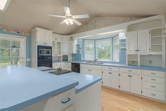 2981 Vivroux Ranch Rd, Seguin, TX 78155 - kitchen with black appliances, vaulted ceiling, open shelves, white cabinetry, and a ceiling fan