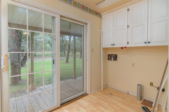 2981 Vivroux Ranch Rd, Seguin, TX 78155 - laundry area featuring light wood finished floors and cabinet space