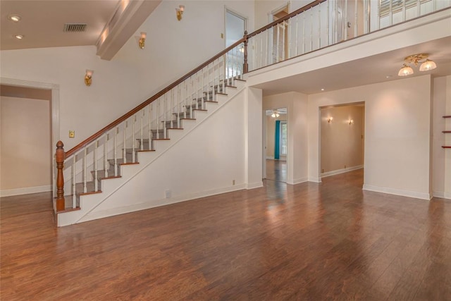 2981 Vivroux Ranch Rd, Seguin, TX 78155 - unfurnished living room featuring wood finished floors, stairway, high vaulted ceiling, and beamed ceiling