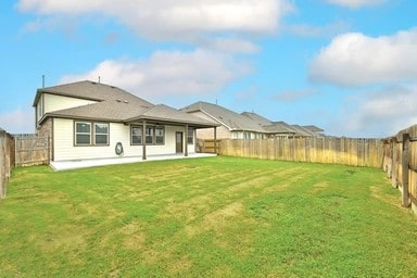17320 Calipatria Ln, Pflugerville, TX 78660 - rear view of house with a fenced backyard and a patio