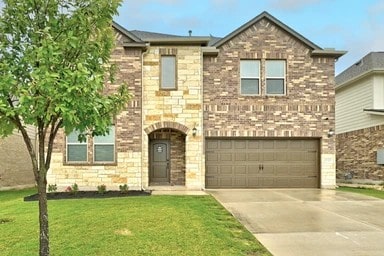 17320 Calipatria Ln, Pflugerville, TX 78660 - view of front of home with concrete driveway, an attached garage, and a front yard