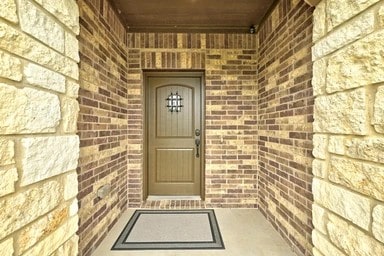 17320 Calipatria Ln, Pflugerville, TX 78660 - property entrance featuring brick siding