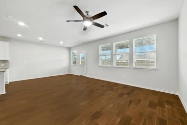 17320 Calipatria Ln, Pflugerville, TX 78660 - unfurnished living room featuring dark wood-style floors, recessed lighting, and ceiling fan