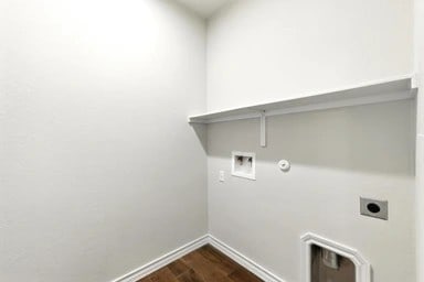 17320 Calipatria Ln, Pflugerville, TX 78660 - laundry room with hookup for an electric dryer, hookup for a washing machine, dark wood finished floors, and gas dryer hookup